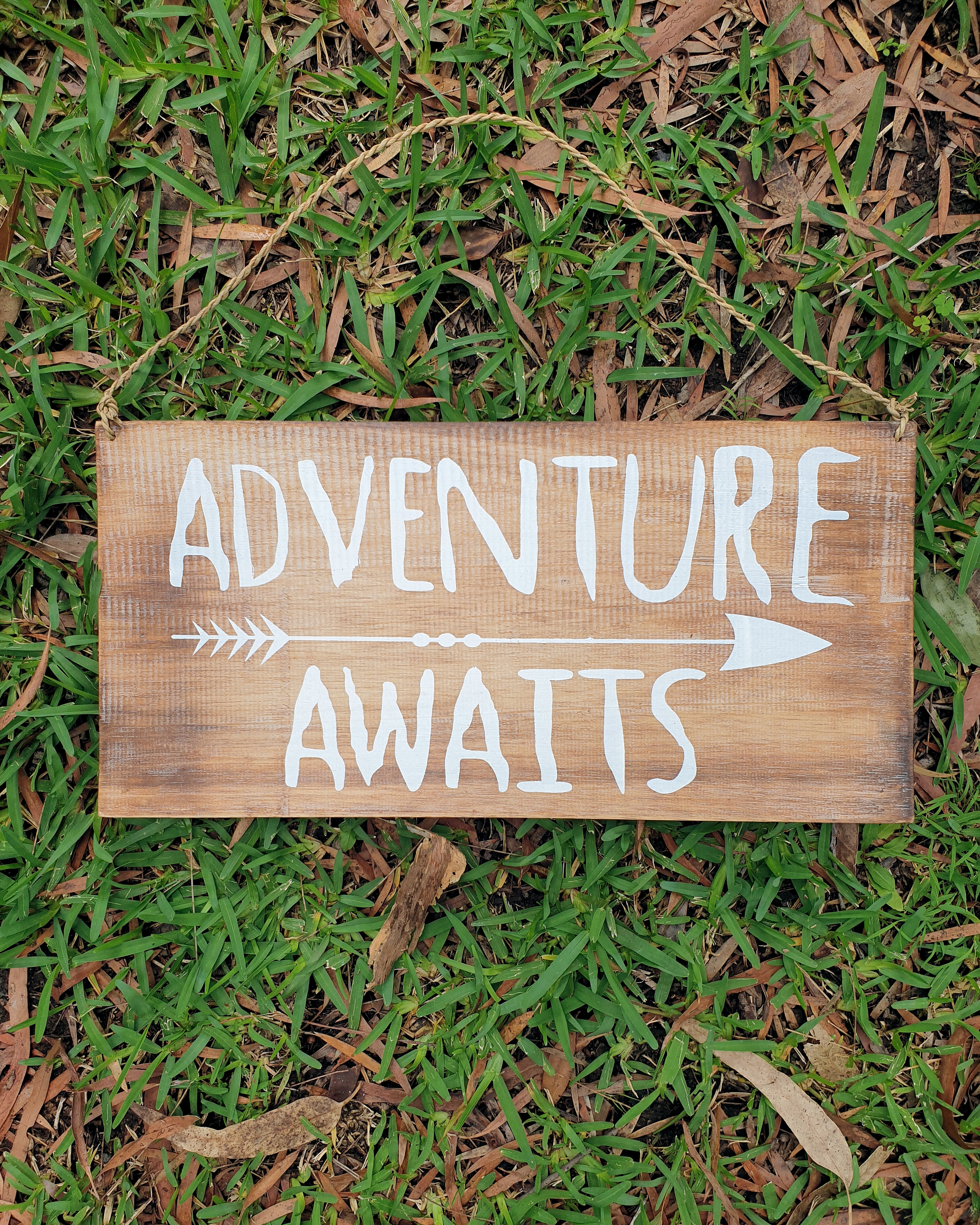 adventure awaits,inspiring quote on timber sign
