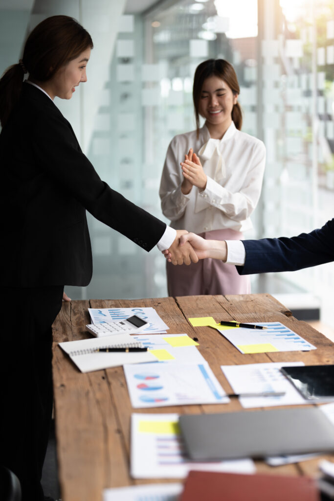 Business people shaking hands, finishing up meeting, business etiquette, congratulation, merger and
