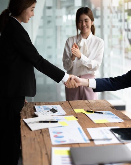Business people shaking hands, finishing up meeting, business etiquette, congratulation, merger and